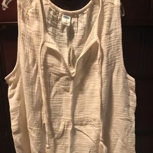 Beige sleeveless top.